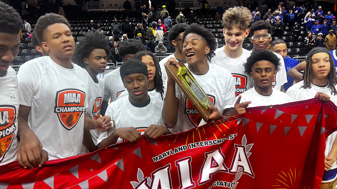 Tristen Wilson (holding plaque) is elated after Our Lady of Mount Carmel won the Maryland Interscholastic Athletic Association (MIAA) A Conference basketball title Tuesday evening at UMBC. The Cougars defeated Saint Frances Academy for their second straight championship.