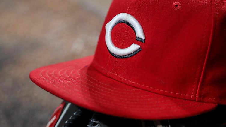 The glove and hat of Cincinnati Reds left fielder Tyler Naquin.