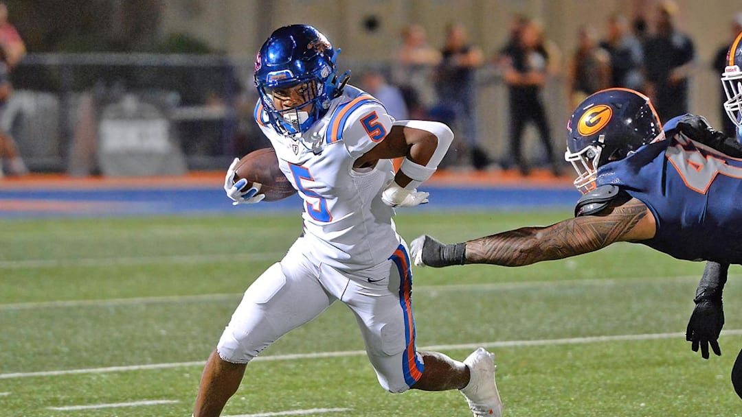 East St. Louis (Ill.) escapes the grasp Bishop Gorman (Nev.) defender.