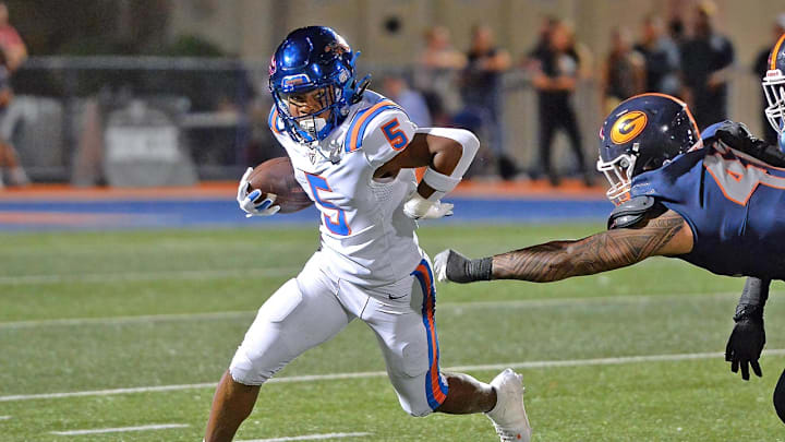 East St. Louis (Ill.) escapes the grasp Bishop Gorman (Nev.) defender.