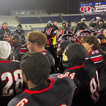 Quince Orchard head coach John Kelley speaks with his squad after it defeated Wise for their second straight Maryland Class 4A state championship.