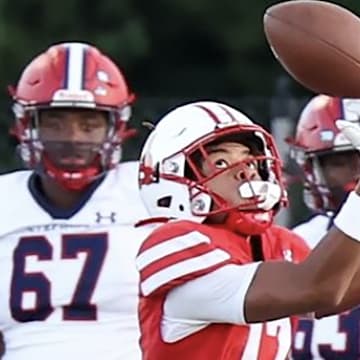 Archbishop Spalding sophomore wide receiver Myles Mcafee looks in pass as  as the Archbishop Stepanic (NY) sideline watches. The Cavaliers rolled to a 45-0 to improve to 3-0.