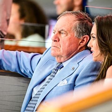Bill Belichick and Jordon Hudson take in an NHL playoff game.