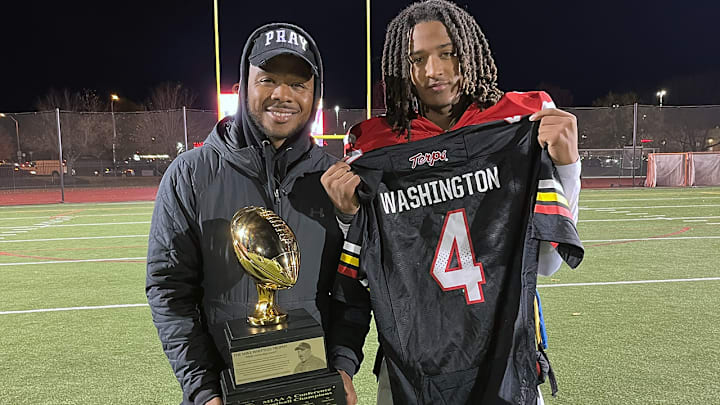 Malik Washington (right) with Archbishop Spalding quarterback coach Aaron Campbell after Saturday’s MIAA A  Conference championship game victory. Washington flashed a University of Maryland jersey baring his name and number and later reconfirmed his commitment to the Terps.