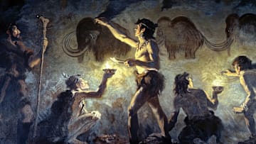 A 1920 mural by paleoartist Charles Robert Knight depicting Cro-Magnon people painting on cave walls at Font-de-Gaume, France.