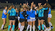Bartram Trail players mob Ali Fletcher and celebrate winning the FHSAA Class 6A girls state soccer championship on Fletcher's header with 19 seconds remaining in a second overtime session on Saturday at Lake Myrtle Sports Complex.