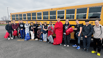 Members of the Danville swimming team are transported to practice each day, while their school is undergoing renovations, by their head coach Gus Moore. Last summer, Moore studied for and received his Class C Drivers License so his team could continue to swim.