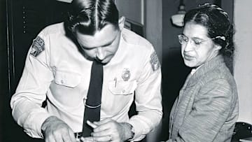 Rosa Parks is fingerprinted by a Montgomery, Alabama, police officer after being arrested for refusing to give up her bus seat to a white passenger.