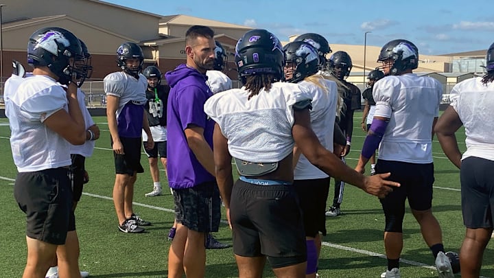 Fulshear football coach Nick Codutti discusses a play call with one of his players during practice this week as the Chargers prepare for Friday's playoff game against Atascocita.