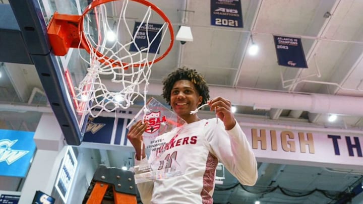 Acaden Lewis, a Kentucky men's basketball commit, is all smiles as he shows off the 2023-24 DCSAA  Class AA championship plaque and a piece of the net after leading Sidwell Friends to the crown.