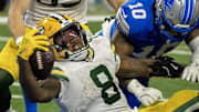 Green Bay Packers running back Josh Jacobs (8) scores a touchdown against the Detroit Lions last season.