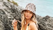 Ellie Thumann was photographed by Ben Watts in Bermuda. Swimsuit top by Andi Bagus. Swimsuit bottom by Lybethras. Hat by Eugenia Kim.