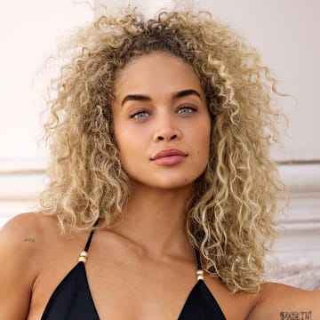 Jasmine Sanders was photographed by Derek Kettela in Zurich, Switzerland. Swimsuit by Hanne Bloch. Jacket by Retrofete.