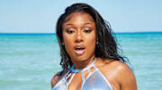 Megan Thee Stallion was photographed by James Macari in Miami, Fla. Swimsuit by Dolce & Gabbana. Bracelet by Lizzie Fortunato. Rings by Nina Berenato.
