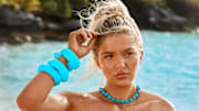 Ellie Thumann was photographed by Ben Watts in Bermuda. Necklace by Lele Sadoughi. Bracelets by Lizzie Fortunato.