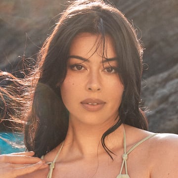 Lauren Chan was photographed by Ben Watts in Bermuda. Swimsuit by Cult Gaia. Bracelets by Alexis Bittar.