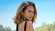 Chrissy Teigen was photographed by Yu Tsai in Los Angeles. Swimsuit by Mugler. Vintage earrings: Essex.