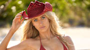 Brittany Mahomes was photographed by Derek Kettela in Belize. Swimsuit by Andi Bagus Hat by Free People.