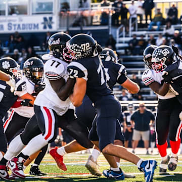 Offensive lineman Trevon Cole-Jenkins (77) makes a block for the Half Hollow Hills East varsity football team last season.
