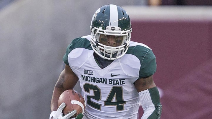 Nov 24, 2012; Minneapolis, MN, USA: Michigan State Spartans running back Le'Veon Bell (24) runs for a first down in the first half against the Minnesota Golden Gophers at TCF Bank Stadium. Mandatory Credit: Jesse Johnson-USA TODAY Sports