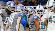 Detroit Lions wide receiver Kalif Raymond (11) celebrates a catch against the Dolphins with Amon-Ra St. Brown (14) 