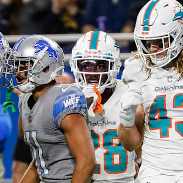 Detroit Lions wide receiver Kalif Raymond (11) celebrates a catch against the Dolphins with Amon-Ra St. Brown (14) 