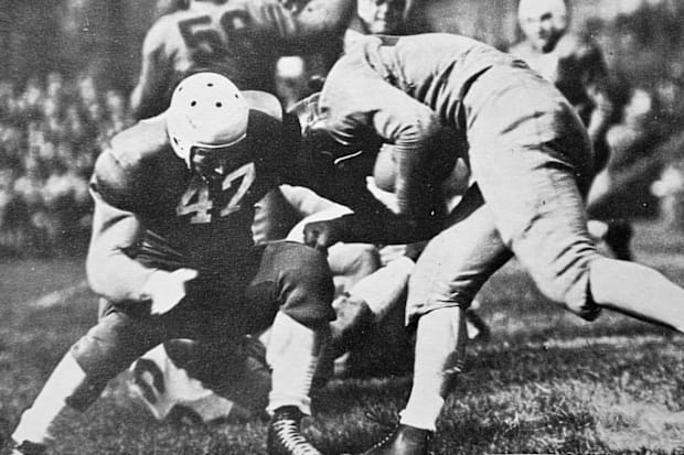 Charley Brock tackles an opposing ball carrier.
