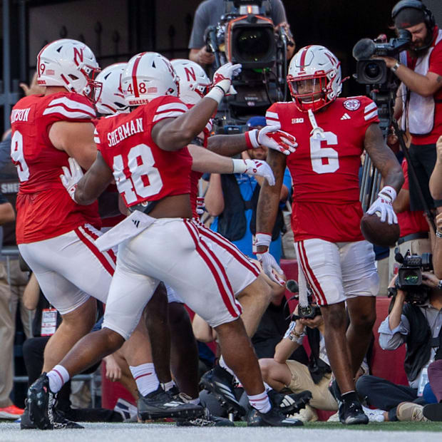 Nebraska defenders prepare to celebrate with defensive back Tommi Hill after his pick six on Colorado's Shedeur Sanders.