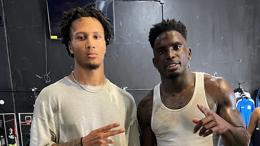 Quanell X Farrakhan Jr.  poses at a workout with Miami Dolphins wide receiver Tyreek Hill in the Houston area on Monday. 