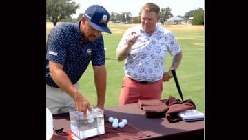 DeChambeau and Evans get to work on some golf balls.