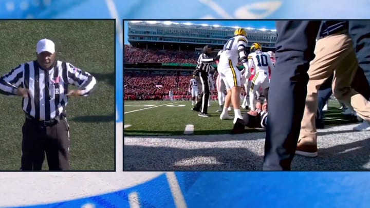 A Big Ten official is knocked over during a scuffle between Michigan and Ohio State players at the 2024 edition of their rivalry.