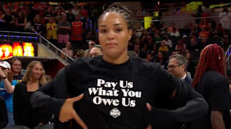 Minnesota Lynx star Napheesa Collier highlights her pregame All-Star game shirt that reads, "Pay Us What You Owe Us." The WNBA players' union is currently negotiating a new Collective Bargaining Agreement (CBA) with the league.