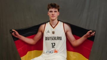 Four-star prospect Eric Reibe poses in his uniform with the German flag after representing Germany on the U18 team.