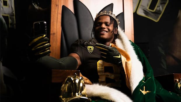 Five-star safety Trey McNutt in an Oregon uniform on a throne.