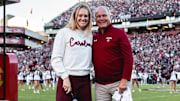 New softball coach Ashley Chastain Woodard with new baseball coach Paul Mainieri at a Gamecock football game.