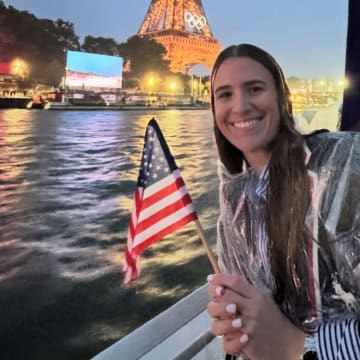 Former Oregon Duck Sabrina Ionescu rides a boat during the parade of nations up the River Seine for the Opening Ceremony of the Paris Olympics.