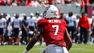 Sep 6, 2025; Raleigh, North Carolina, USA; Virginia Cavaliers tight end Sage Ennis (0) runs with the football by North Carolina State Wolfpack safety Brody Barnhardt (29), cornerback Brian Nelson II (7) and cornerback Jackson Vick (22) during the first half of the game at Carter-Finley Stadium. Mandatory Credit: Jaylynn Nash-Imagn Images