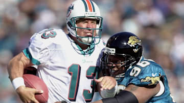 Miami Dolphins quarterback Dan Marino (L) is sacke