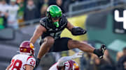 Oregon tight end Kenyon Sadiq hurdles over USC cornerback DeCarlos Nicholson as the Oregon Ducks host the USC Trojans on Nov. 22, 2025, at Autzen Stadium in Eugene, Oregon.
