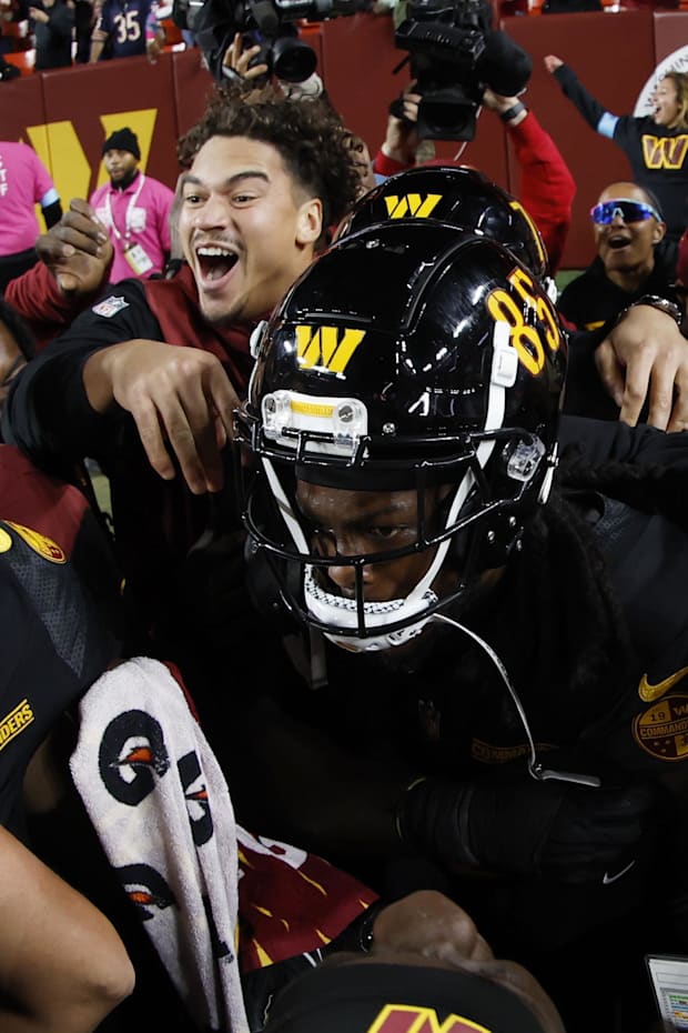 Commanders broad recipient Noah Brown celebrates with teammates after catching a game-winning orphan Mary Pass during the last game