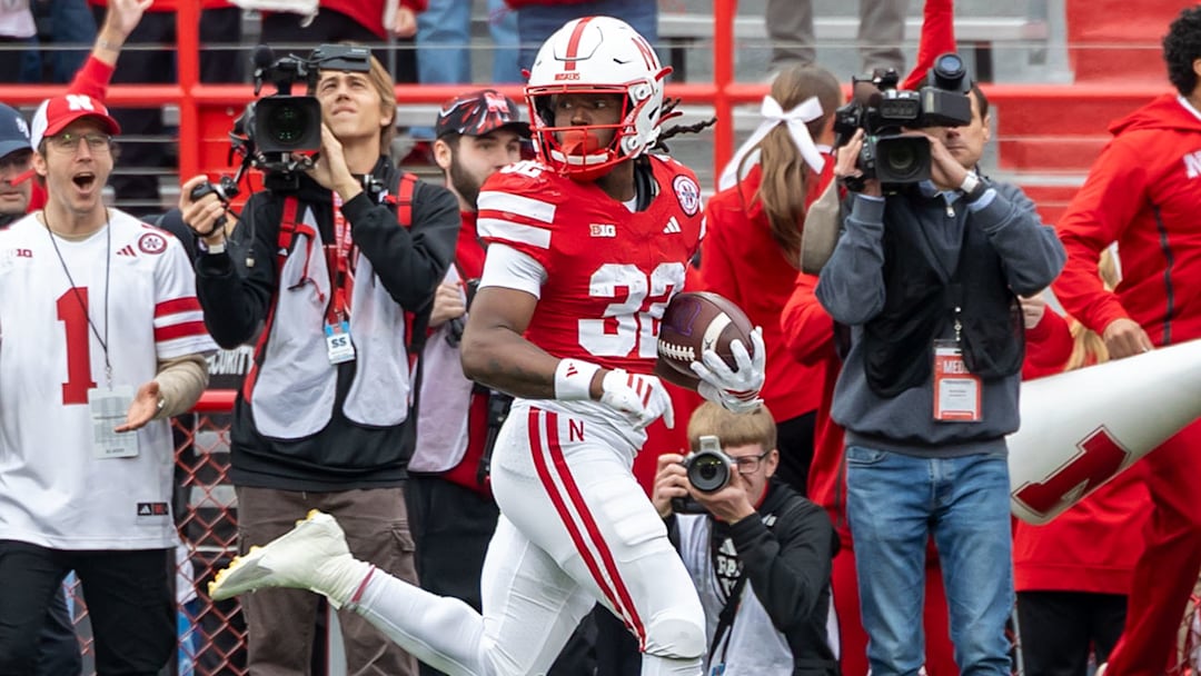 Nebraska's Kenneth Williams peeks back during his 95-yard kickoff return for a touchdown against Northwestern.