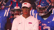 Mississippi Rebels head coach Lane Kiffin stands with his players before a game against the Florida Gators