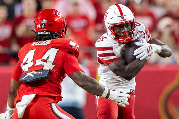 Nebraska running back Emmett Johnson picks up 11 yards against Cincinnati in Kansas City.