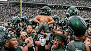 Michigan State celebrates with the Paul Bunyan Trophy after beating Michigan on Saturday, Oct. 30, 2021, at Spartan Stadium in East Lansing.