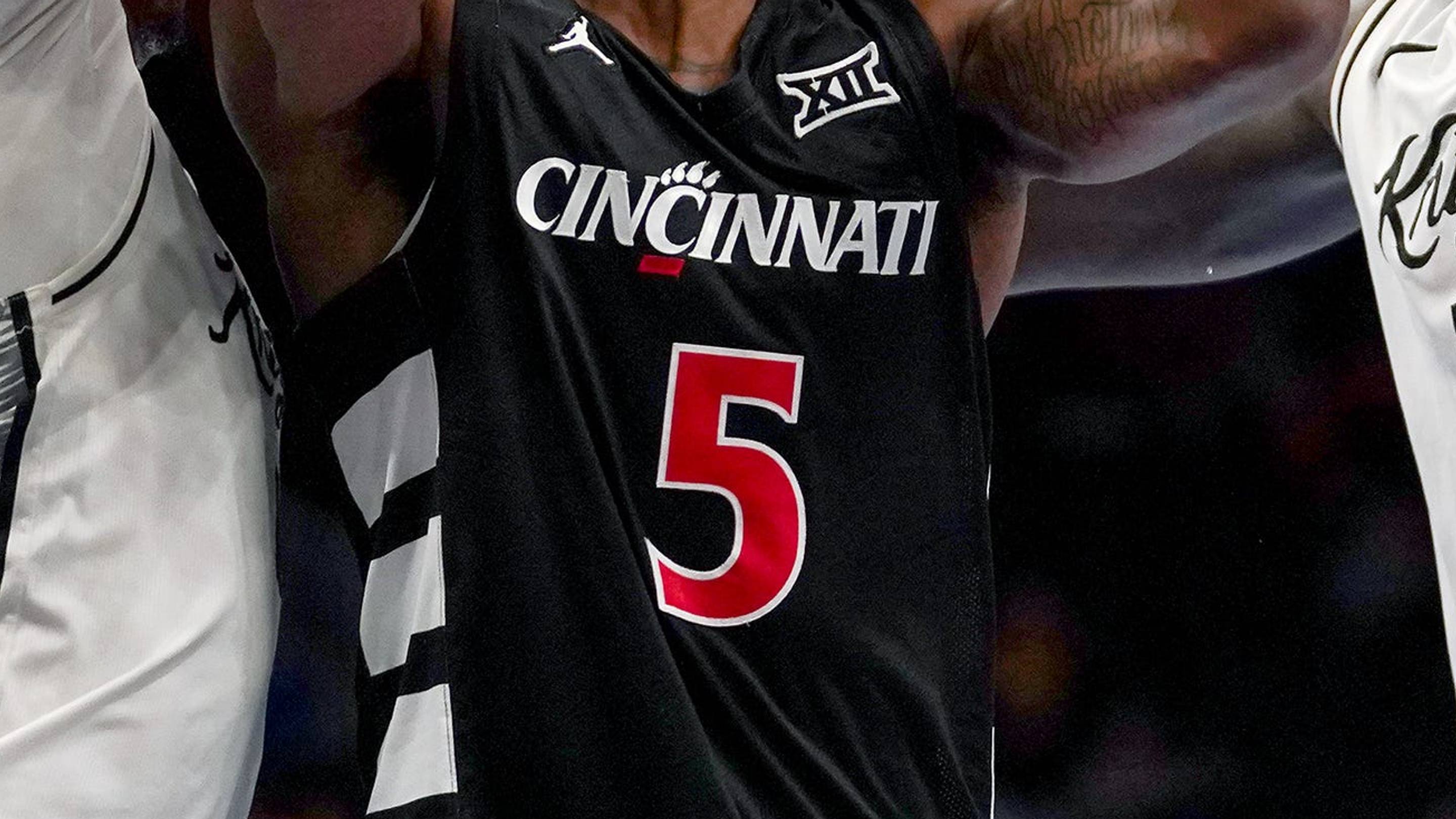 Cincinnati Bearcats guard Sencire Harris (5) is double teamed by UCF Knights players in the first half of the second round of the Phillips 66 Big 12 Men’s Basketball Tournament between the Cincinnati Bearcats and UCF Knights, Wednesday, March 11, 2026, at T-Mobile Center in Kansas City, MO. | USA TO