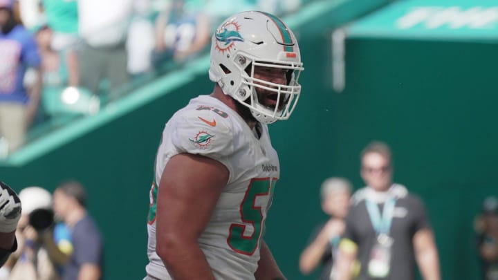 Miami Dolphins running back Chase Edmonds (2) celebrates scoring a touchdown with teammates lineman Connor Williams, center, and Robert Hunt, left, during the fourth quarter of an NFL game at Hard Rock Stadium in Miami Gardens, Sept. 25, 2022.