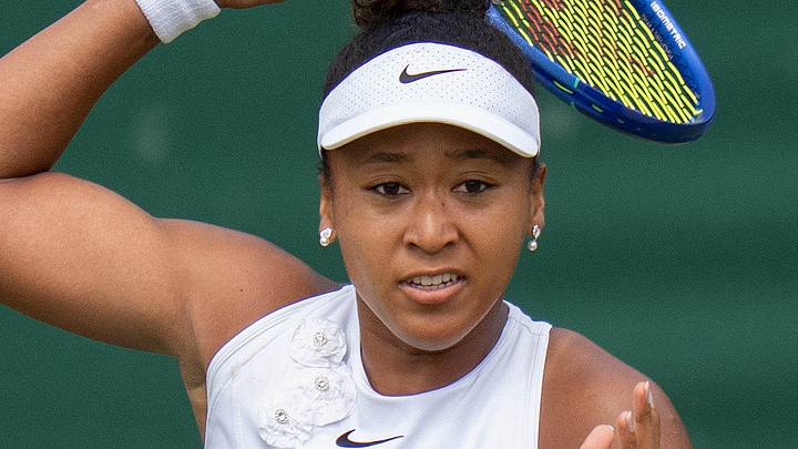 Naomi Osaka returns a shot during her match at Wimbledon