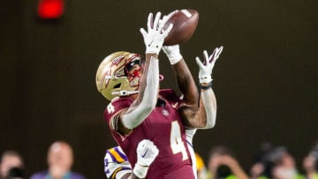 Florida State Seminoles wide receiver Keon Coleman (4) catches a pass from Florida State Seminoles quarterback Jordan Travis (13) during a game against the LSU Tigers at Camping World Stadium on Sunday, Sept. 3, 2023.