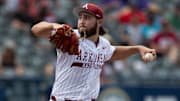 Arkansas Razorbacks' Zach Root (33) pitches against the Ole Miss Rebels during the SEC baseball tournament at Hoover Met in Birmingham, Ala.