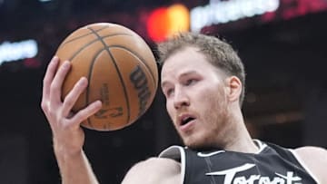 Toronto Raptors center Jakob Poeltl gets control of a rebound against the Boston Celtics.